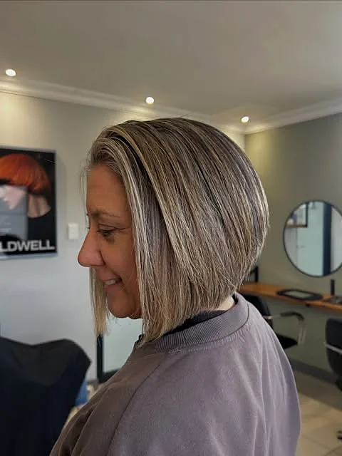 A softly blended silver and blonde bob, seen in profile